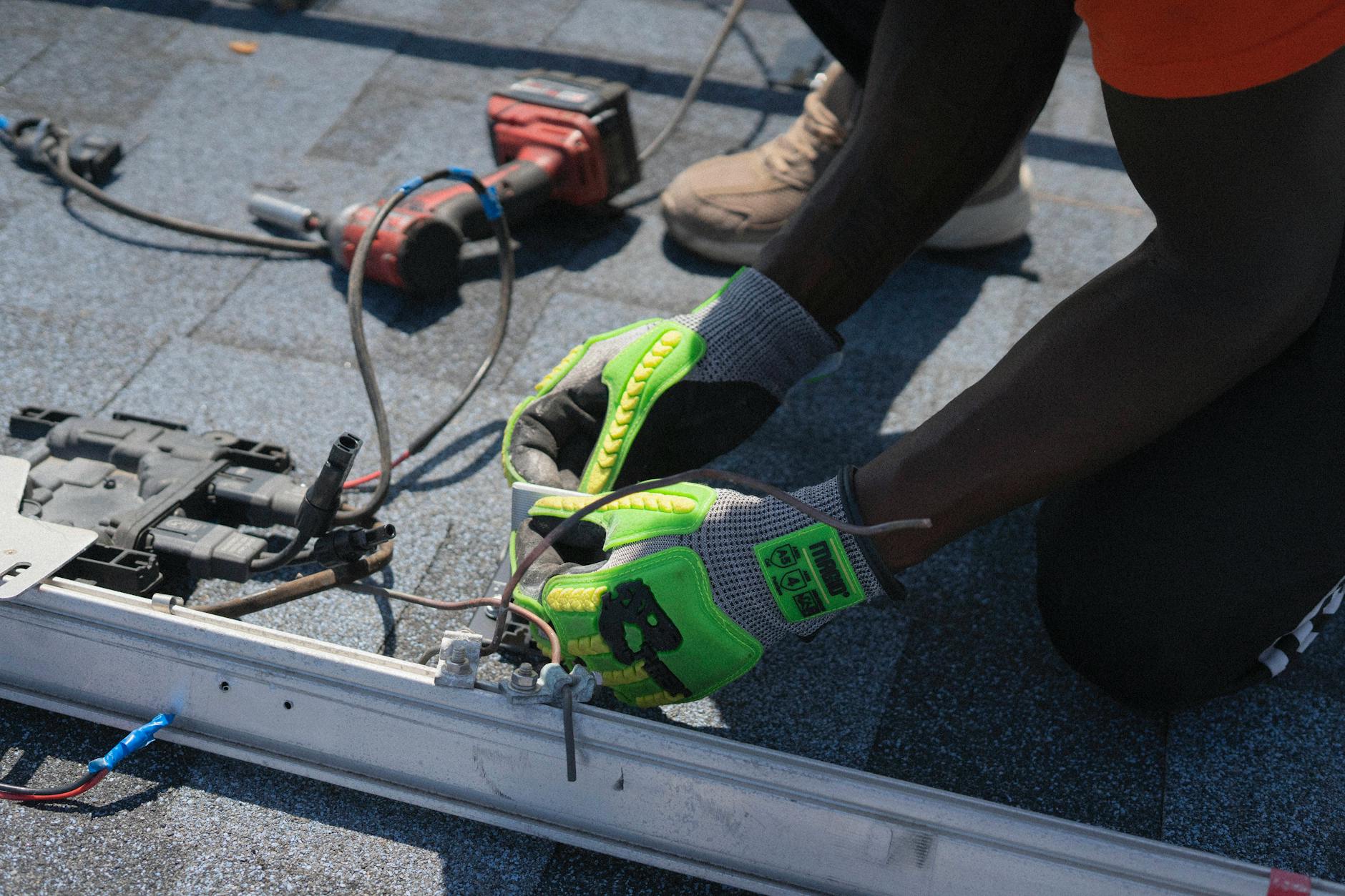An Iron Peak Roofing technician showing a homeowner a sample of UV-resistant asphalt shingles in Anaheim.