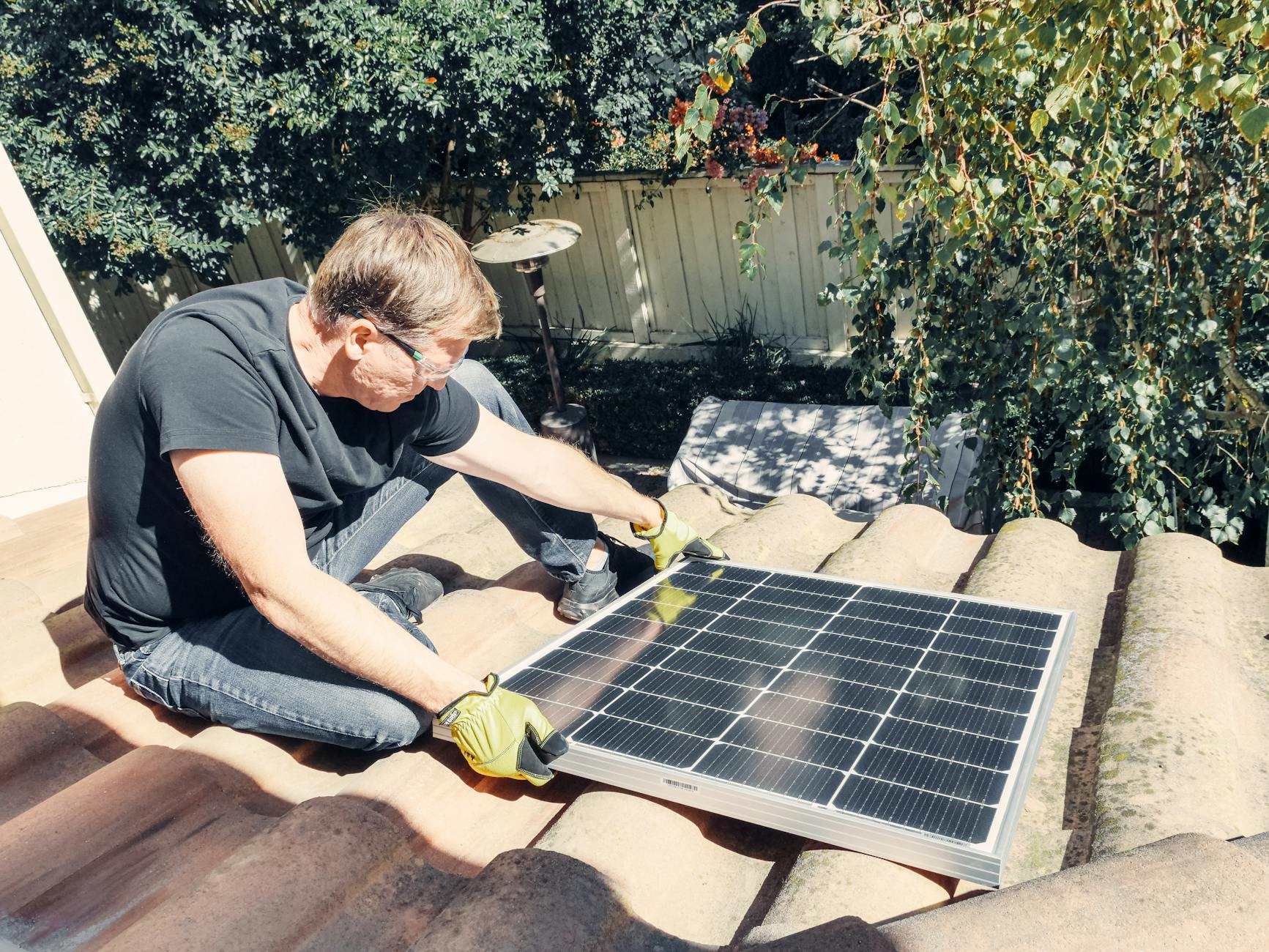 A close-up of a roofing professional showing a Santa Ana homeowner the differences between various energy-efficient shingle samples.